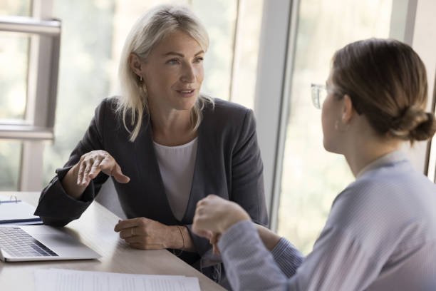 Manager running a GROW coaching conversation with a frontline team member